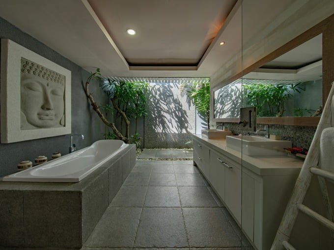 Bathroom design trend of adding natural elements like wood and plants and greenery also stone flooring