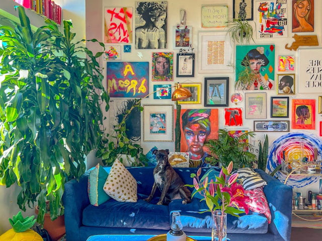 Maximalism style design full of personal component, art pieces  in the wall, vibrant blue color soda an unique cushions  