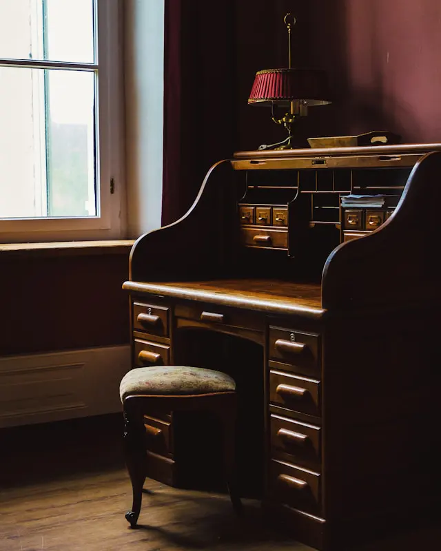 vintage wood desk as key elements in dark academia interior design