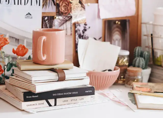 dorm room desk with couple of book and mug on it