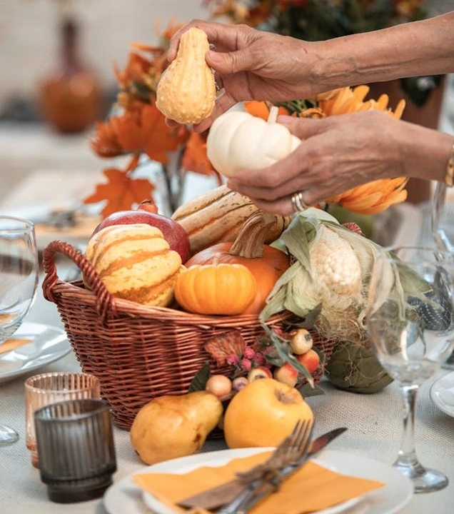 pumpkin arrangement as centerpiece in Thanksgiving table setting