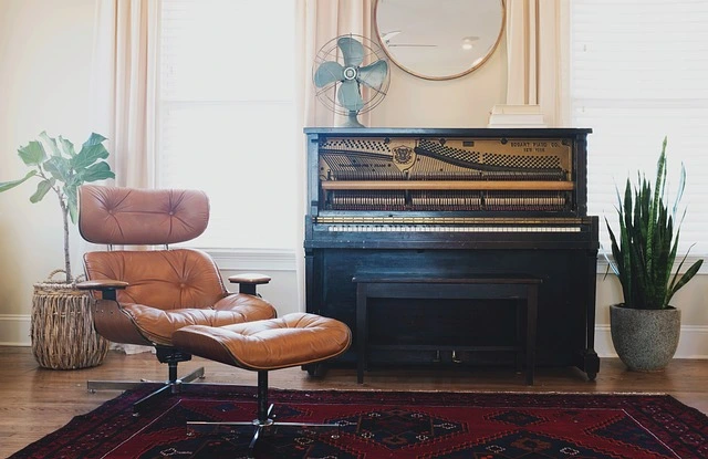 mid-century chair beside vintage piano create original and unique look which have got trendy in 2025 home design 